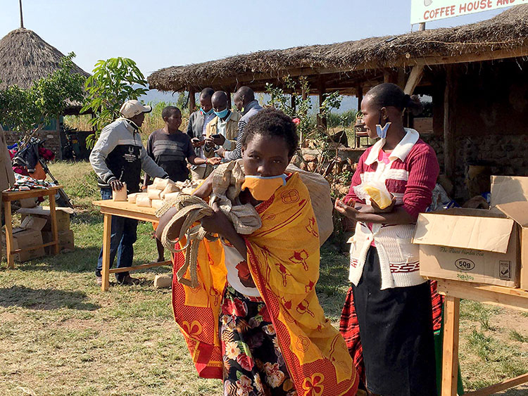 Picture of a mom in Kenya taking food home