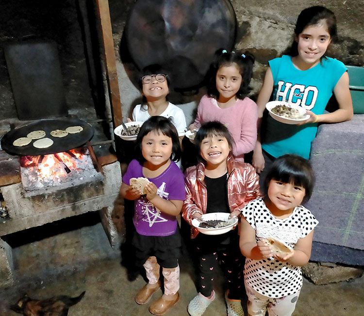 Picture of Mexican children with food on their hands.