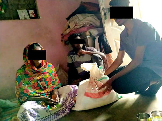 Picture of a Pakistani family receiving food aid