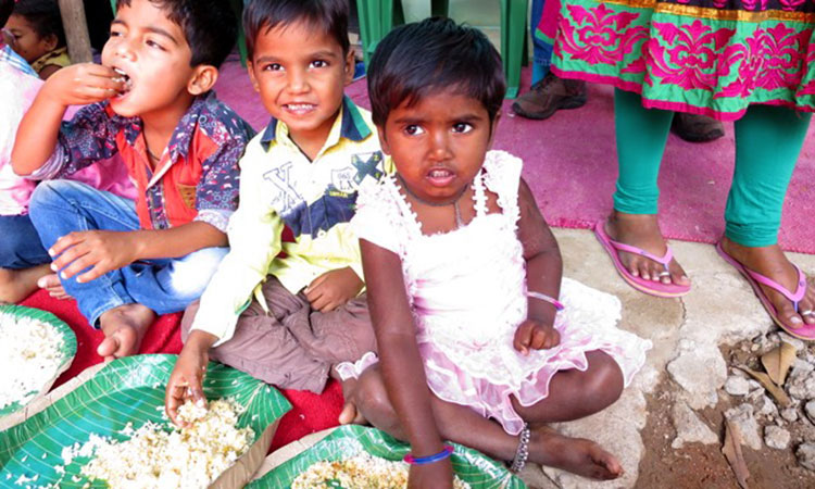 Children at a leprosy colony in Hyderabad, India eating