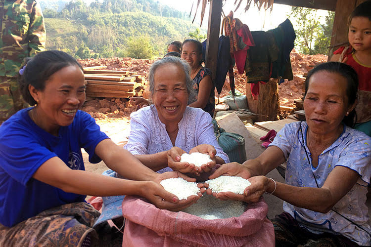 Women in Laos with rice bags