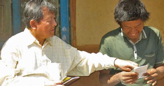 Picture of missionary sharing gospel tract and new testament