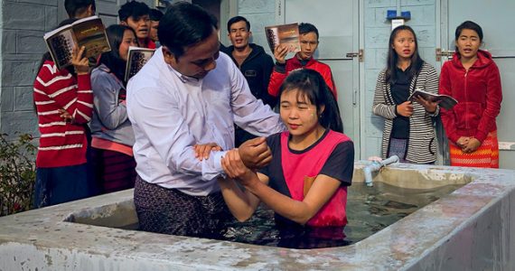 Picture of Mo Sai being baptized