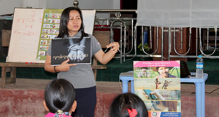 Picture of social worker telling families about harm of orphanages