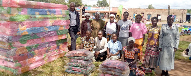 Pictures of widows in Kenya receiving blankets and mattresses