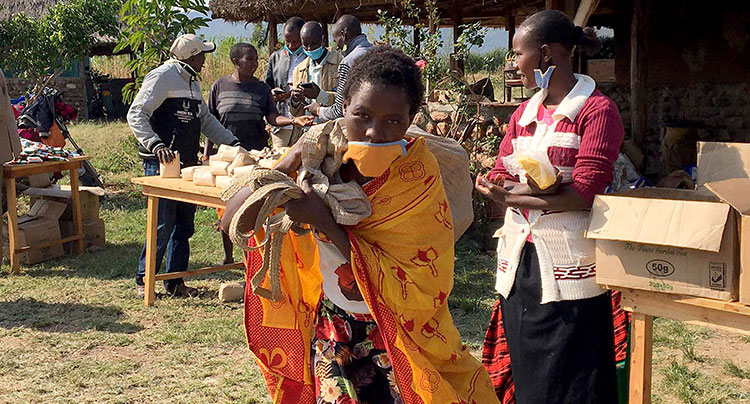 Picture of a mom in Kenya taking food home