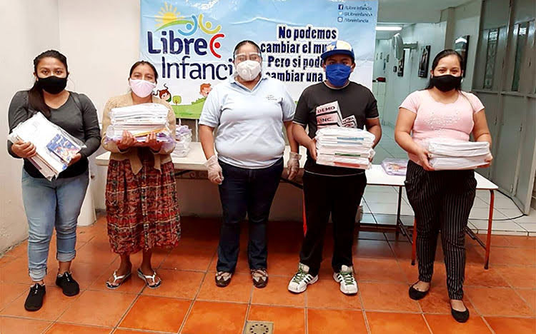 Picture of parents in Guatemala receiving educational packets