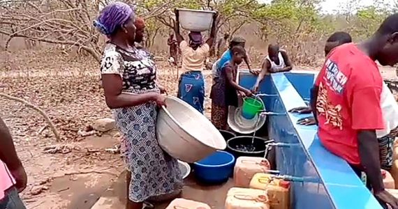 Picture of people in Nigeria filling their containers with clean water