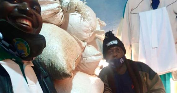 picture of oni and edwin in front of the bountiful harvest