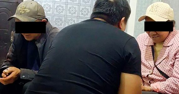 Image of missionary praying with couple