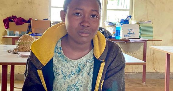 Image of Tabitha from Rwanda reading Bible