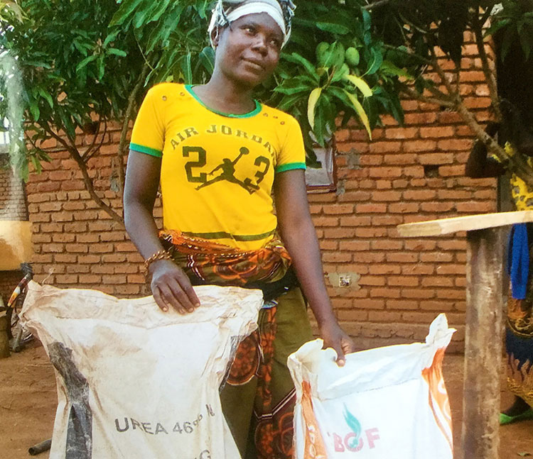 A picture of Mary receiving seed and fertilizer
