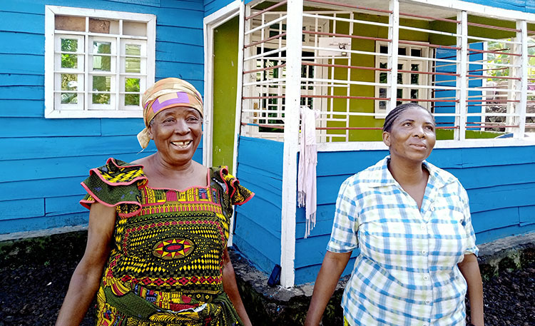 Picture of refugees in front of their new home