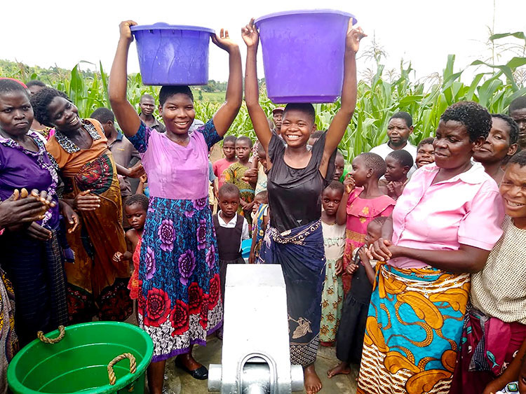 Image of villagers in Malawi enjoying new well