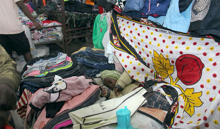 Image of baby sleeping in clothing shop