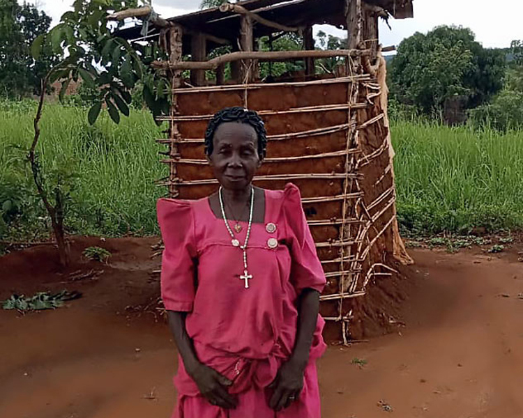 Image of Namuga near her outhouse