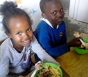 Halmona eating lunch with a classmate