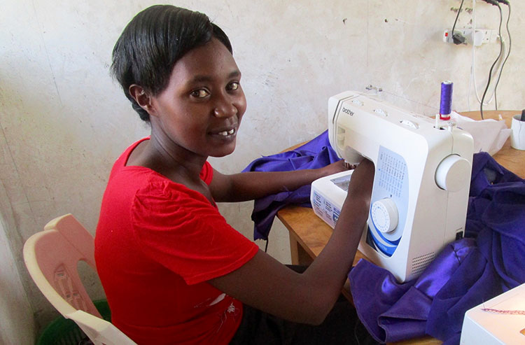 Elizabeth sewing a dress