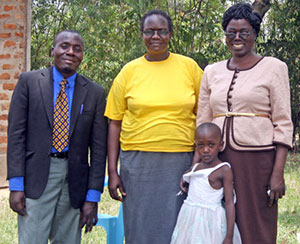 John, at left, with Joy Valley's chaplain, and Head of Curriculum
