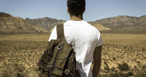 young man with backpack fleeing pakistan