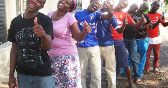 samuel and patricia giving thumbs up with men at Philemon house