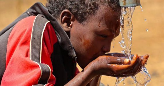 child drinking pure water from well in Ethiopia