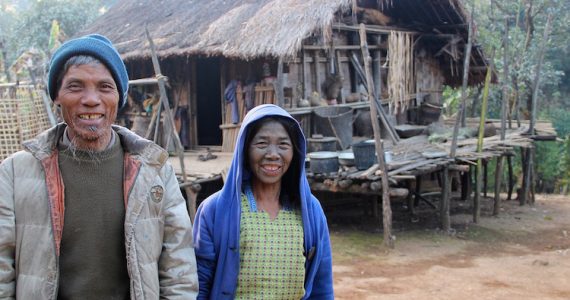 Poor couple in front of hut in chin state Myanmar