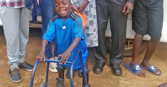 4-year-old Richard smiling with walker