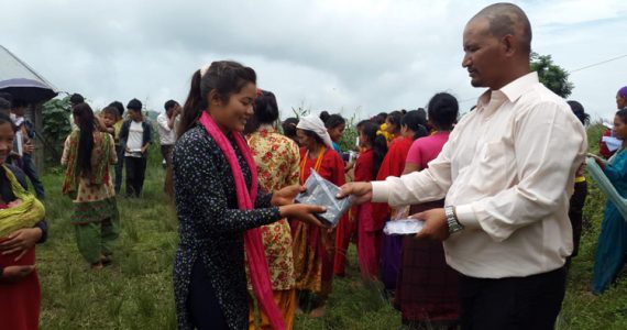 Picture of Tibetan young woman receiving her own copy of God's Word
