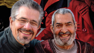 Picture of David Servant with joyful Syrian refugee