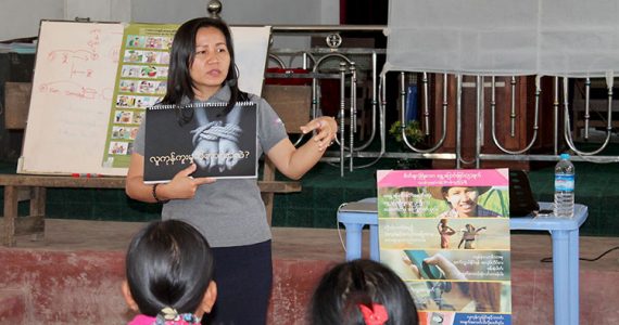 Picture of social worker telling families about harm of orphanages