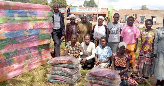 Pictures of widows in Kenya receiving blankets and mattresses