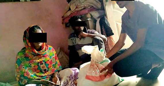 Picture of a Pakistani family receiving food aid