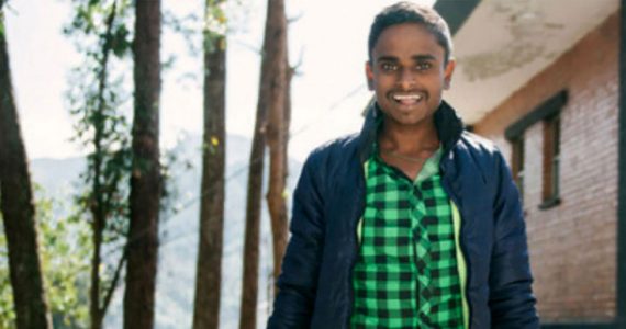 Santosh in India standing two prosthetic legs