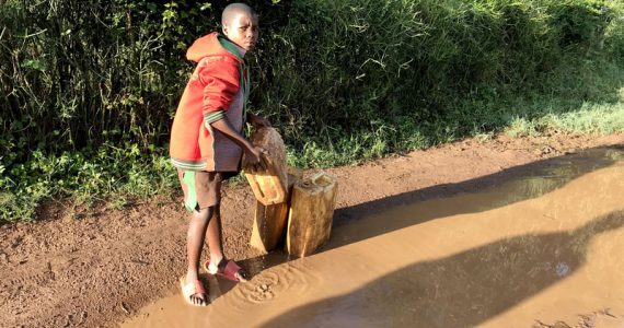 Picture of child in Africa drinking dirty water