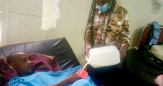 Image of prisoner receiving milk in Rwanda