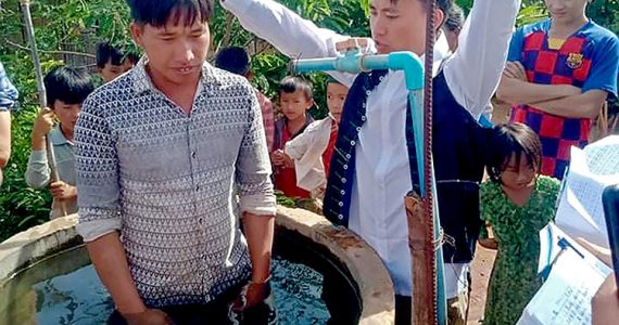 Image of villagers being baptized